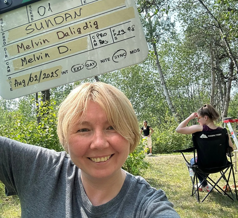 Gulfia holding a clapperboard